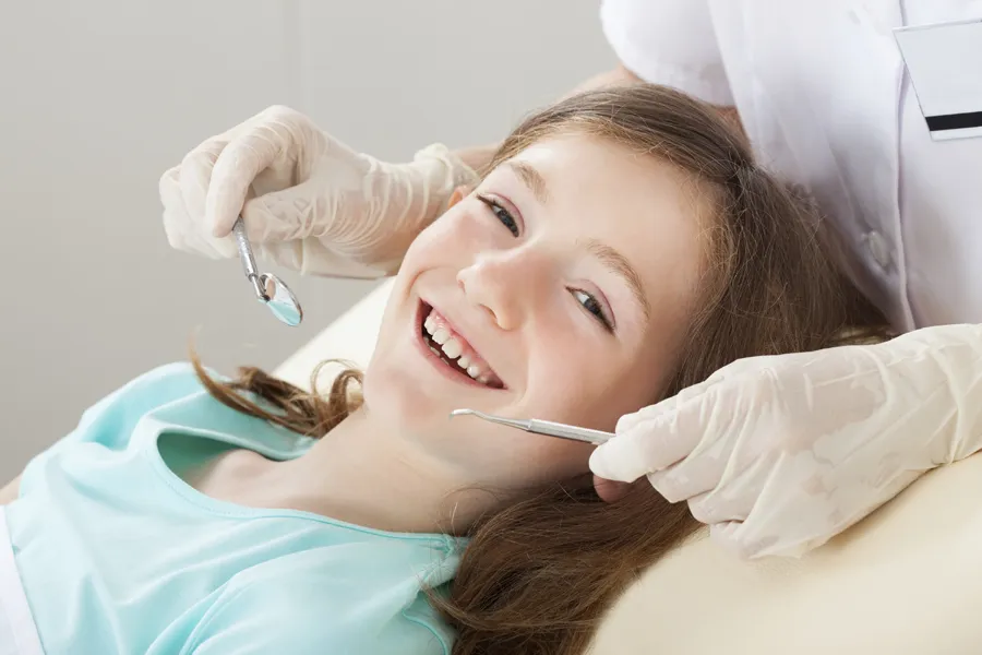 A smiling girl in the dental chair